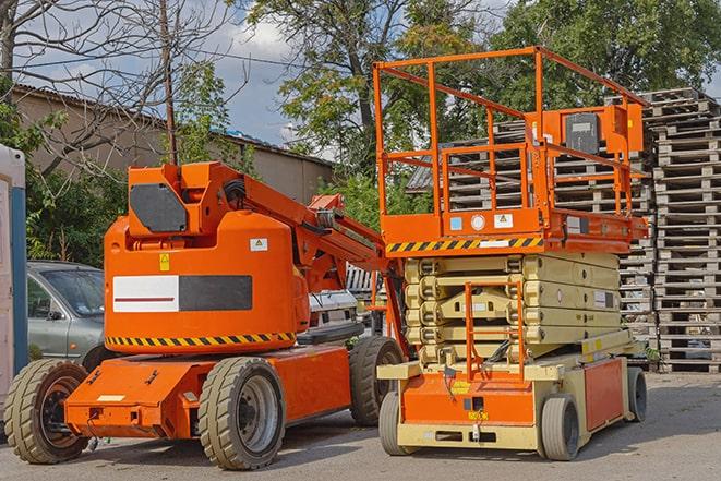 forklift carrying pallets in warehouse in Friend